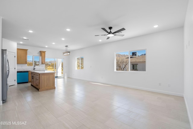 kitchen with dishwashing machine, open floor plan, and freestanding refrigerator