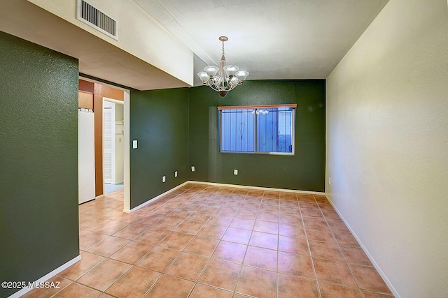empty room with a chandelier, baseboards, visible vents, and light tile patterned flooring