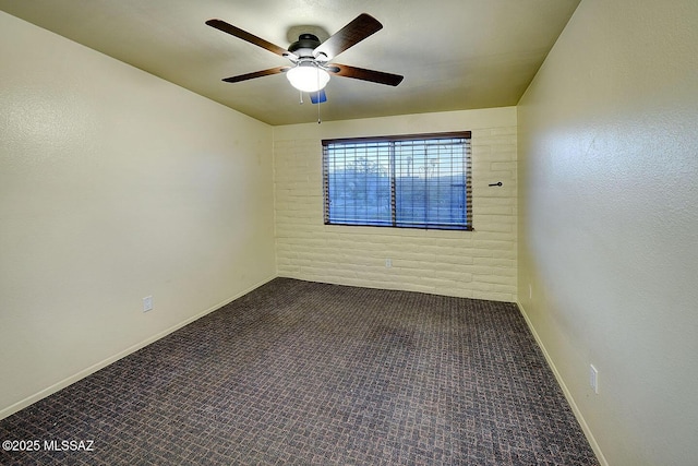 carpeted empty room with baseboards and ceiling fan