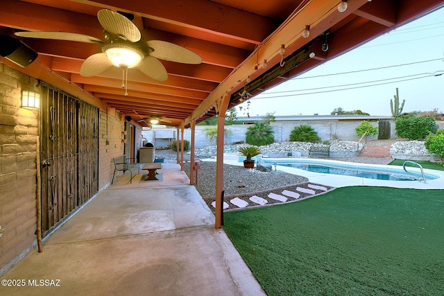 view of patio with a ceiling fan and an outdoor pool