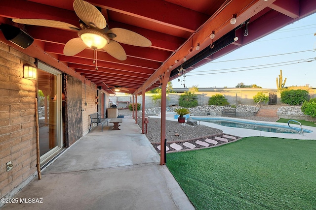 view of patio / terrace featuring a ceiling fan, an outdoor pool, and a fenced backyard
