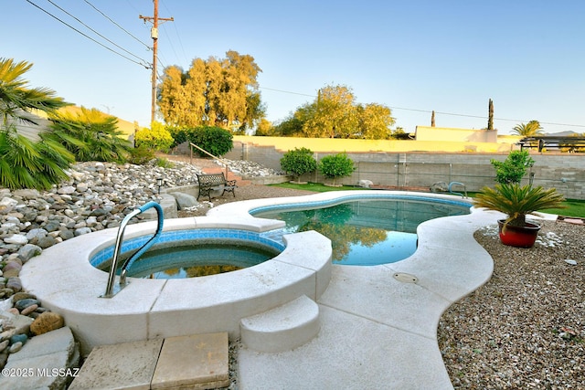 view of pool featuring a fenced in pool, an in ground hot tub, and a fenced backyard