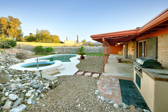 view of yard with an in ground hot tub, a fenced in pool, a fenced backyard, and a patio area