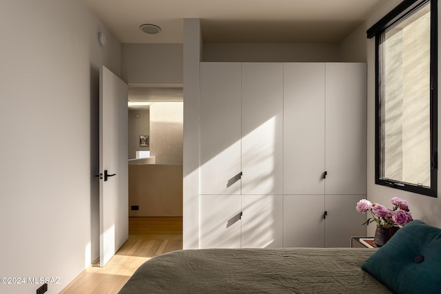 unfurnished bedroom with light wood-style floors