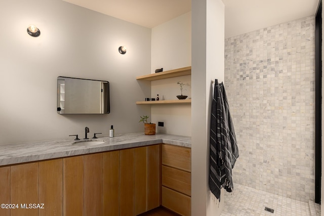 interior space with vanity and tiled shower