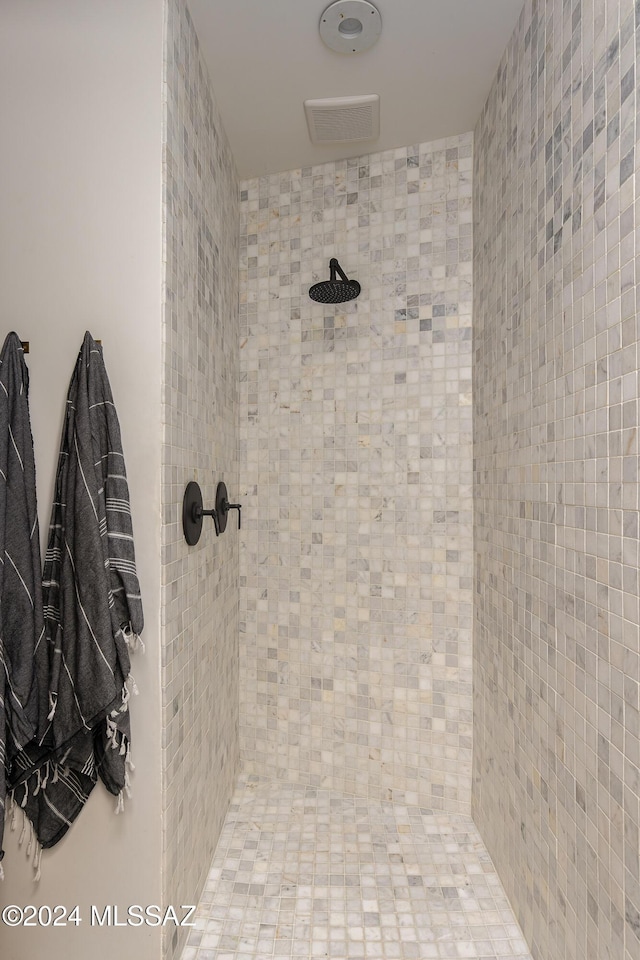 bathroom featuring visible vents and tiled shower