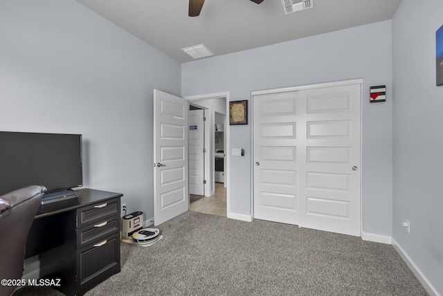 carpeted office featuring visible vents, baseboards, and a ceiling fan