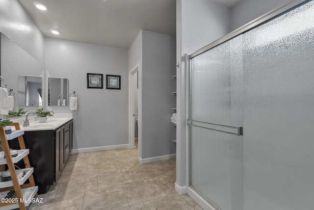 full bath with vanity, baseboards, recessed lighting, a stall shower, and tile patterned flooring