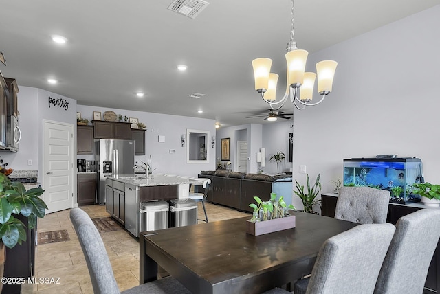 dining room with ceiling fan with notable chandelier, recessed lighting, and visible vents