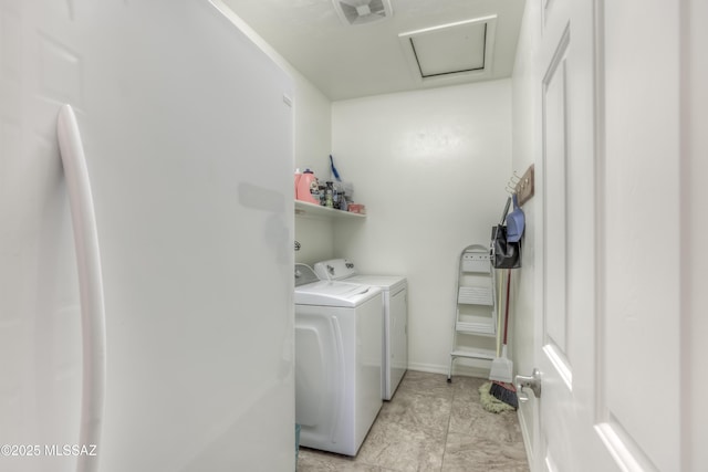 laundry room featuring laundry area, attic access, visible vents, and washing machine and clothes dryer