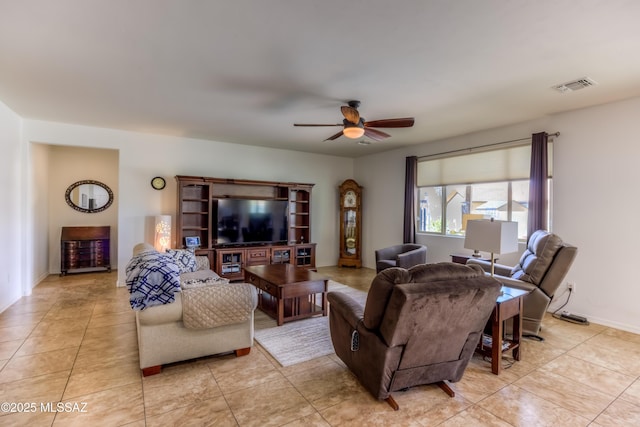 living room with light tile patterned floors, visible vents, and ceiling fan