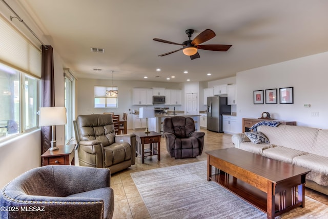 living room featuring recessed lighting, a ceiling fan, visible vents, and light tile patterned floors