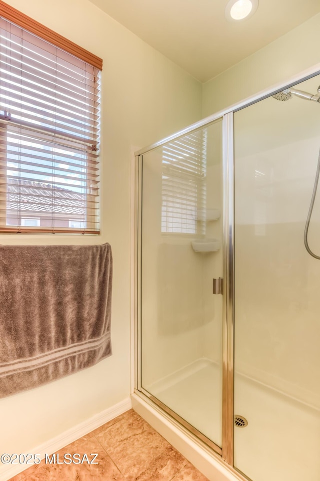 bathroom featuring tile patterned floors and a stall shower