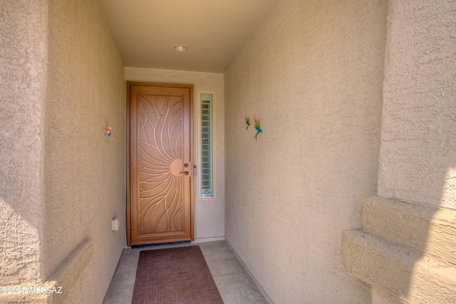 view of exterior entry featuring stucco siding