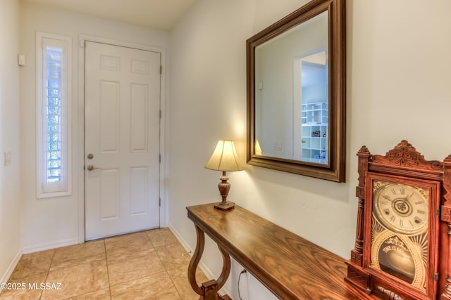 entryway featuring light tile patterned floors and baseboards