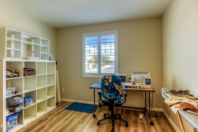 office space with baseboards and wood finished floors