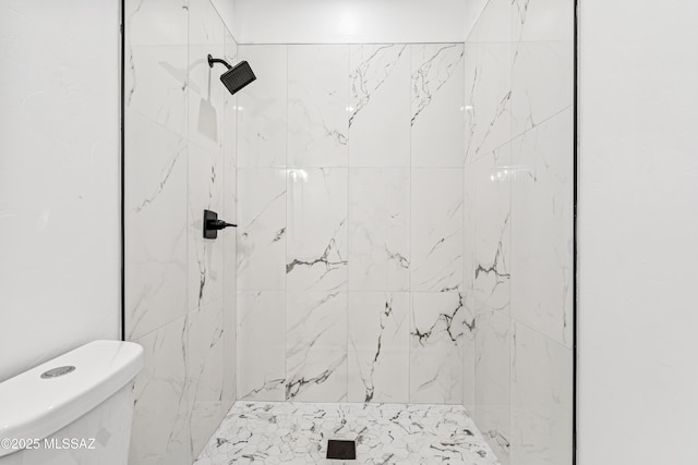 bathroom with toilet and a shower stall