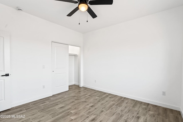 unfurnished bedroom with a closet, light wood-type flooring, and baseboards