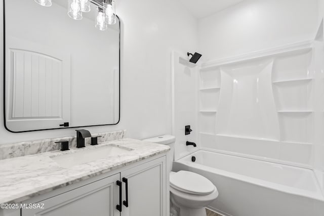 bathroom with bathing tub / shower combination, toilet, and vanity