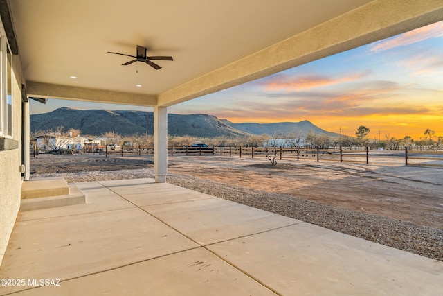 view of patio with a mountain view and ceiling fan