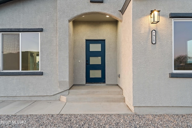 doorway to property with stucco siding