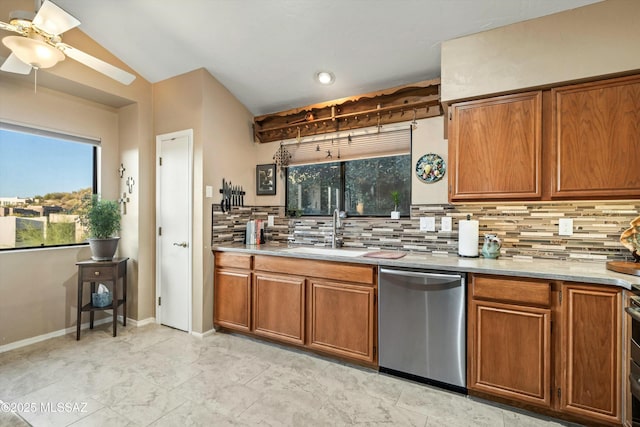 kitchen with brown cabinetry, a sink, backsplash, and stainless steel dishwasher