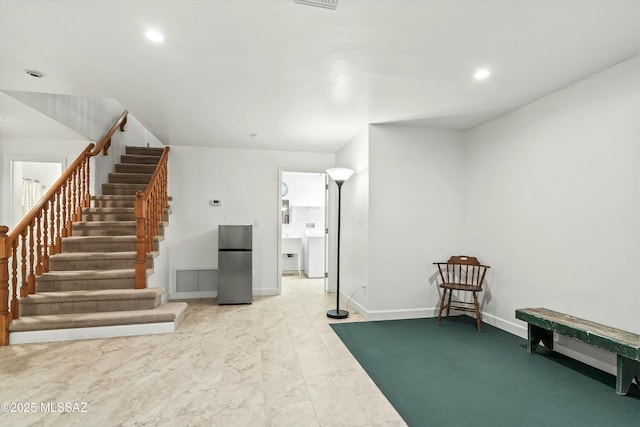 interior space featuring stairway, recessed lighting, baseboards, and freestanding refrigerator