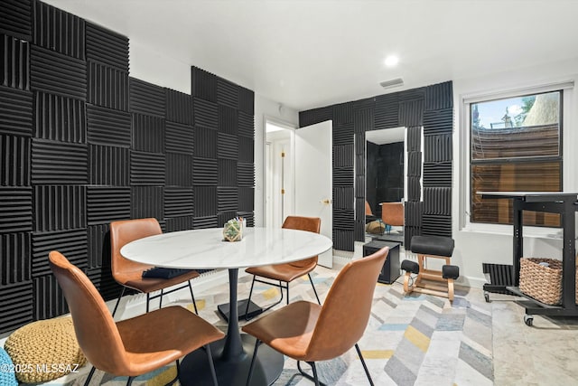 dining area with recessed lighting, visible vents, baseboards, and an accent wall