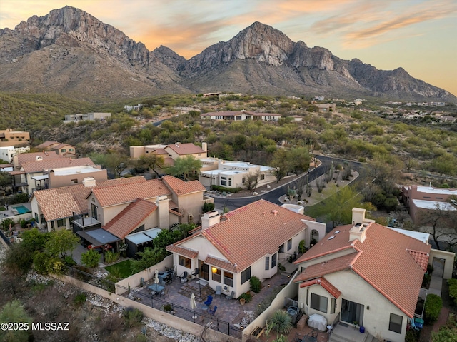 aerial view at dusk with a mountain view and a residential view