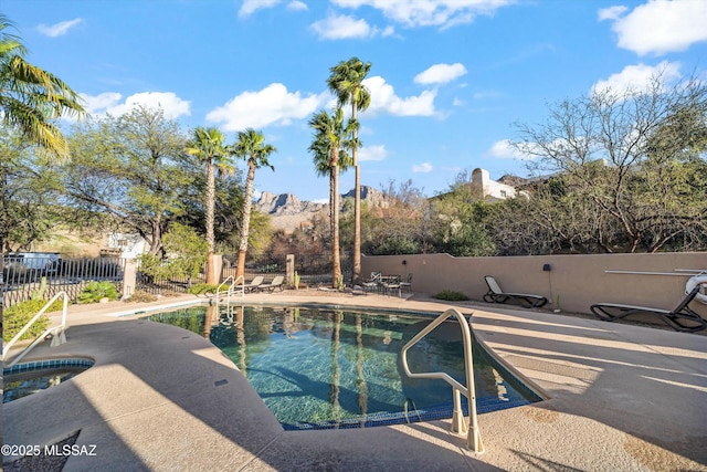 view of pool featuring a fenced in pool, a jacuzzi, a patio, and fence