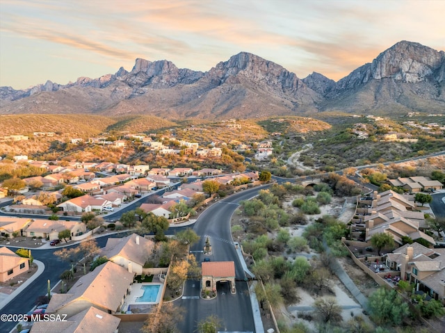 aerial view at dusk with a mountain view and a residential view