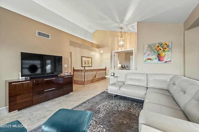 living area with visible vents and vaulted ceiling