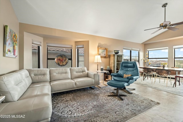 living area featuring a ceiling fan and vaulted ceiling