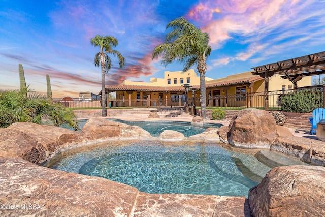 view of pool with a fenced in pool, a patio area, an in ground hot tub, and fence