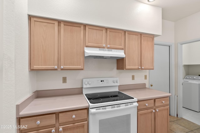 kitchen with light tile patterned floors, washer / clothes dryer, light countertops, under cabinet range hood, and white range with electric stovetop