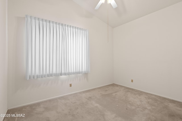 carpeted spare room with baseboards, ceiling fan, and vaulted ceiling