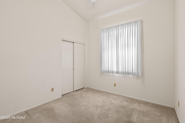 spare room featuring vaulted ceiling and carpet floors