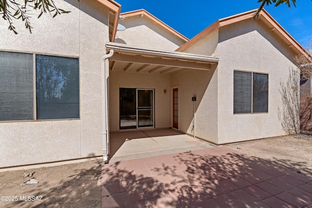 back of house featuring a patio area and stucco siding