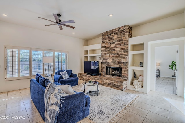 tiled living area with built in features, recessed lighting, a stone fireplace, and a ceiling fan