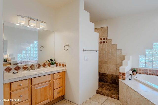 full bathroom with tile patterned floors, a garden tub, walk in shower, and vanity