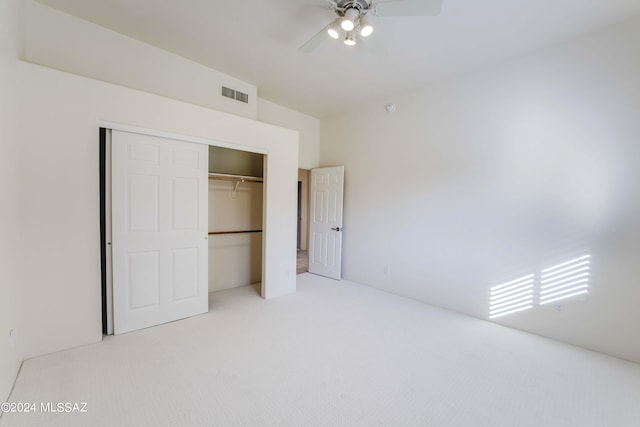 unfurnished bedroom with light colored carpet, visible vents, a closet, and ceiling fan