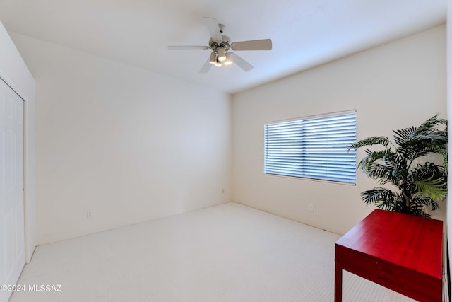 carpeted empty room featuring ceiling fan