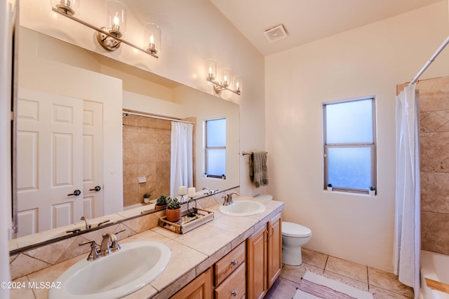 full bath with a healthy amount of sunlight, visible vents, and a sink