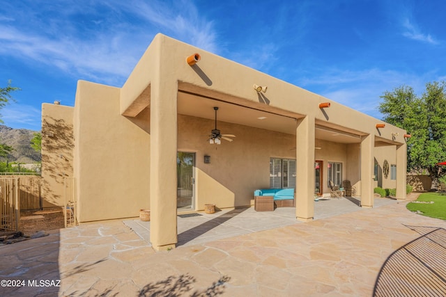 view of patio with outdoor lounge area, ceiling fan, and fence