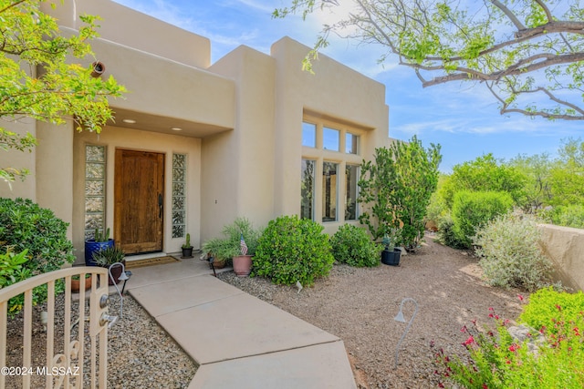 doorway to property with stucco siding