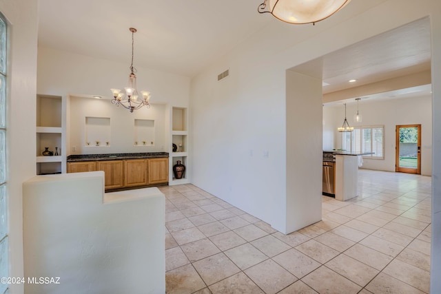 kitchen with visible vents, built in features, light tile patterned floors, an inviting chandelier, and hanging light fixtures