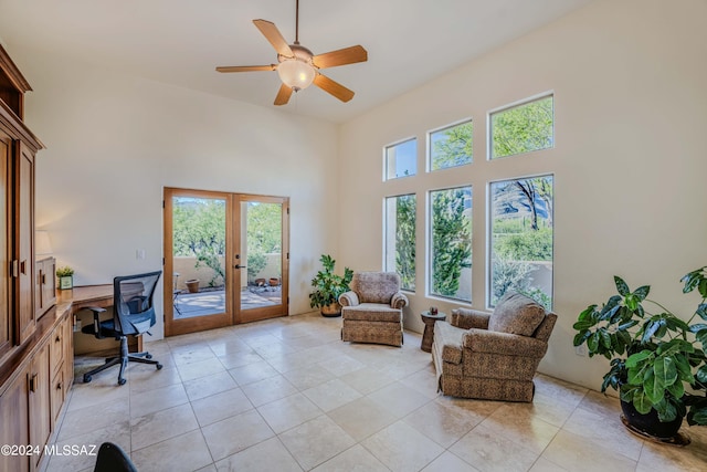 office featuring a ceiling fan, a high ceiling, light tile patterned floors, and french doors