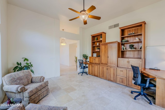 office with visible vents, a ceiling fan, and built in desk