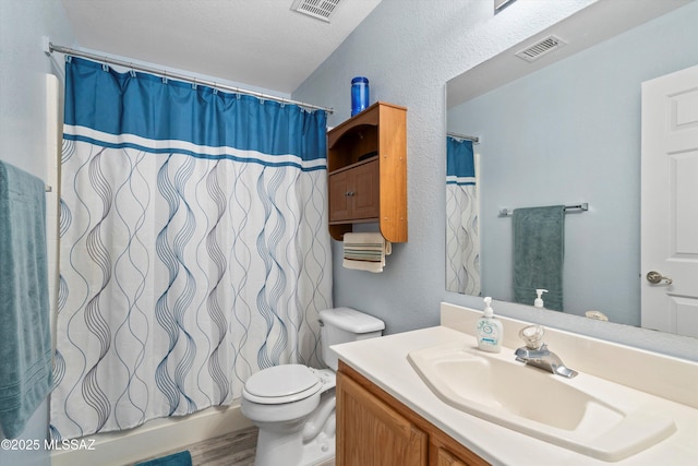 bathroom featuring visible vents, toilet, vanity, and a shower with curtain