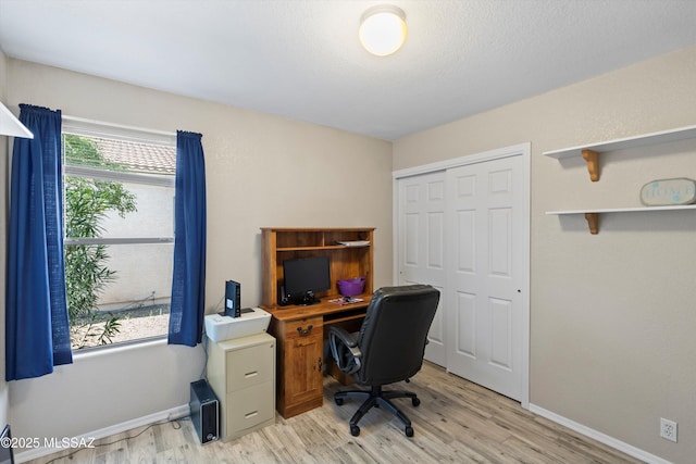 office area with light wood-style flooring and baseboards